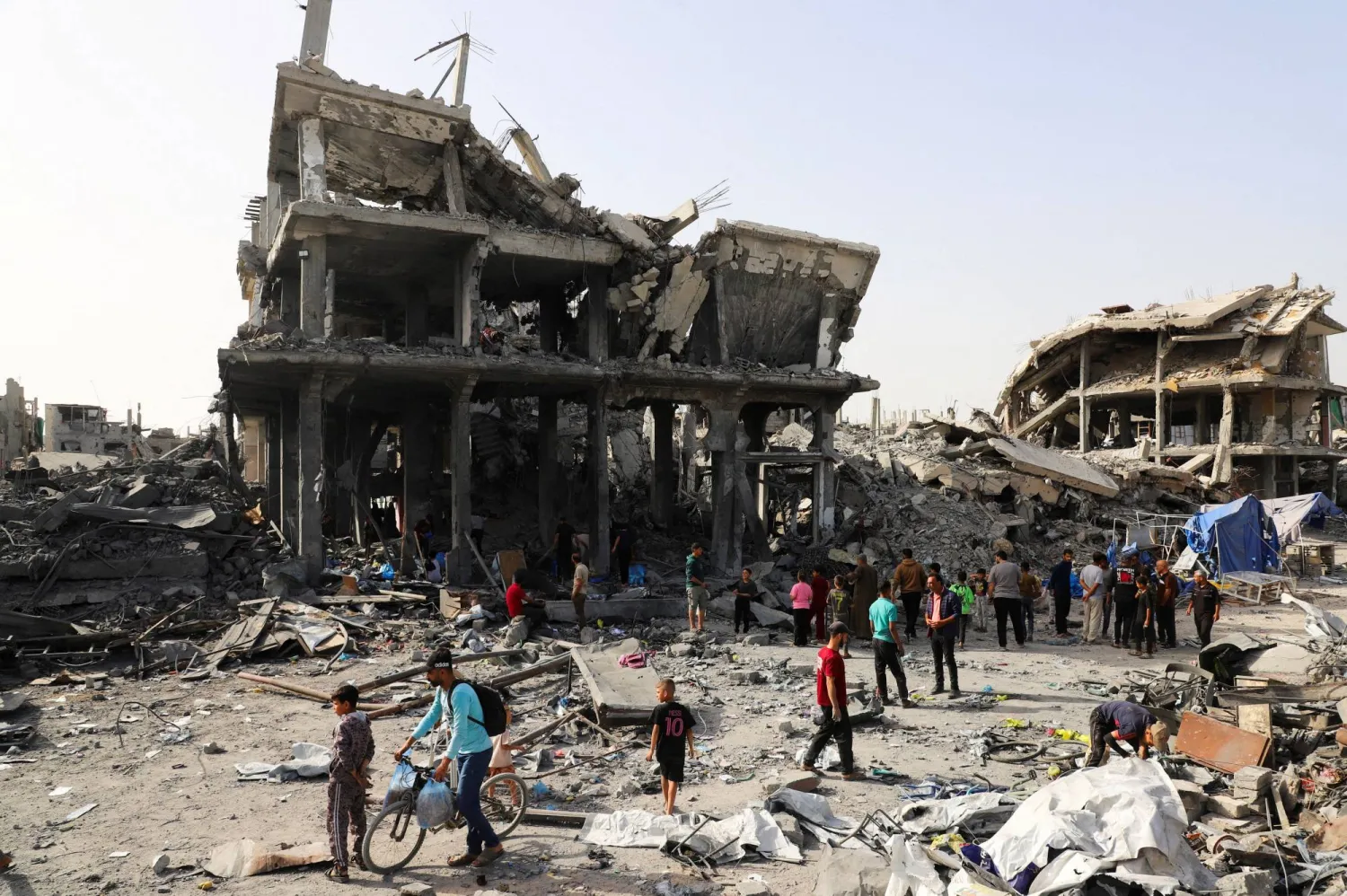 Palestinians inspect the site of an Israeli strike on a house that was pre-warned by the Israeli military to evacuate before the strike was carried out late on Monday, in Jabalia refugee camp in the northern Gaza Strip May 19, 2026. (Reuters)