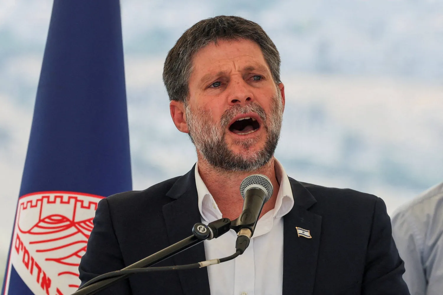 Israeli Finance Minister Bezalel Smotrich speaks at a press conference regarding settlements expansion for the long-frozen E1 settlement, that would split East Jerusalem from the occupied West Bank, near the Israeli settlement of Maale Adumim in the Israeli-occupied West Bank, August 14, 2025. (Reuters)