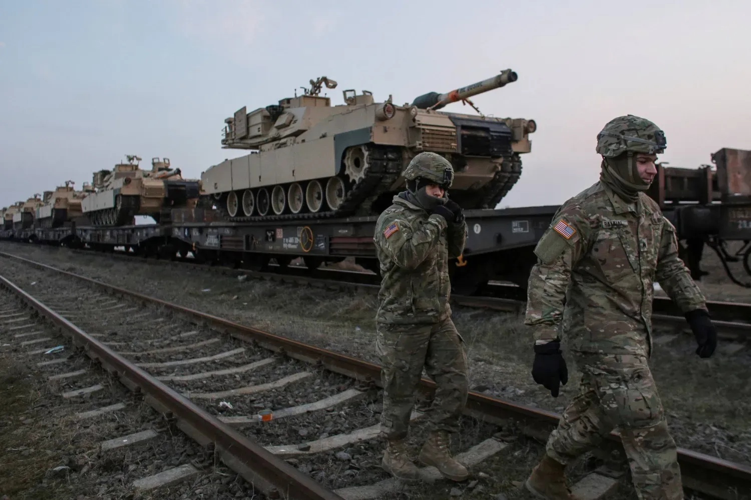 Amerikan askerleri, Romanya'daki Mihail Kogalniceanu Hava Üssü'nde M1 Abrams tanklarının yanında yürüyor (Arşiv- Reuters)