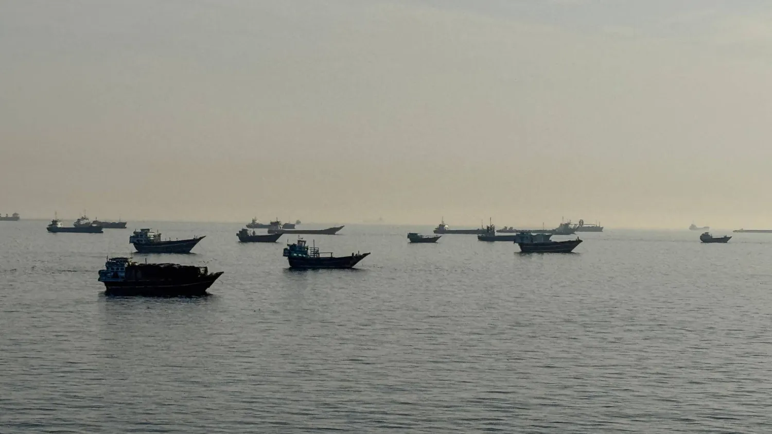 Vessels are seen anchored in the Strait of Hormuz, off the port city of Khasab on Oman's northern Musandam Peninsula on May 17, 2026. (AFP)