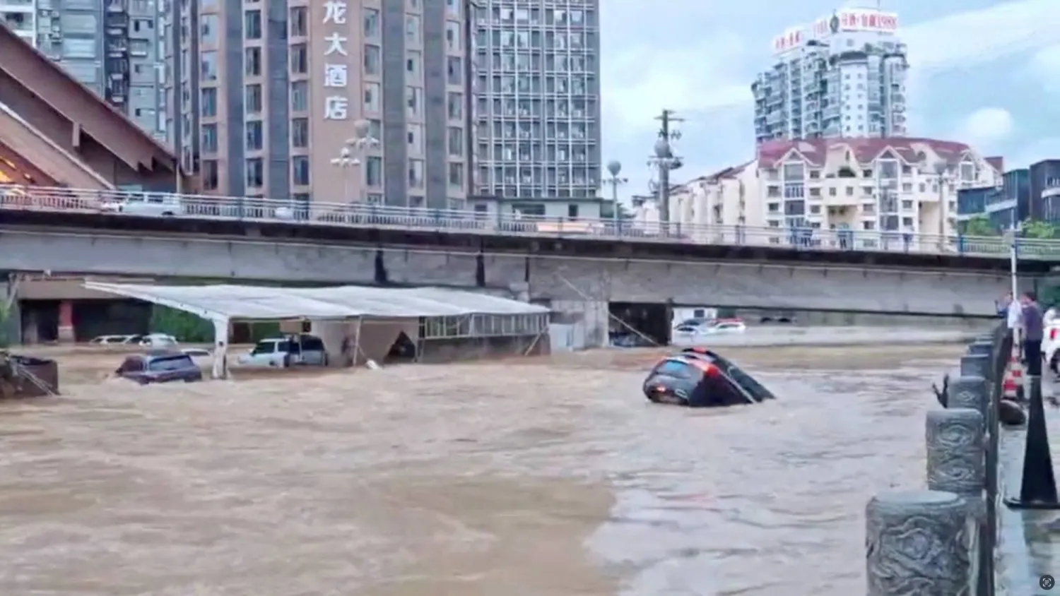 Cars partially submerged in floodwaters after heavy rainfall in Duyun, Guizhou Province, China, May 19, 2026, in this still image obtained from a social media video. (Social Media/via Reuters)