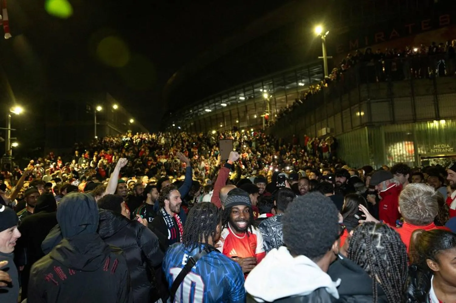 Arsenal fans celebrate their team winning the English Premier League, outside the Emirates Stadium in London on May 20, 2026. (AFP)