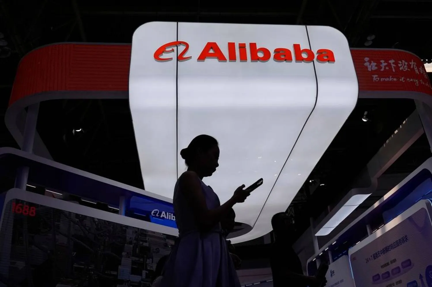 A visitor walks in front of Alibaba booth during the 3rd China International Supply Chain Expo at the China International Exhibition Center, in Beijing, China, Friday, July 18, 2025. (AP)