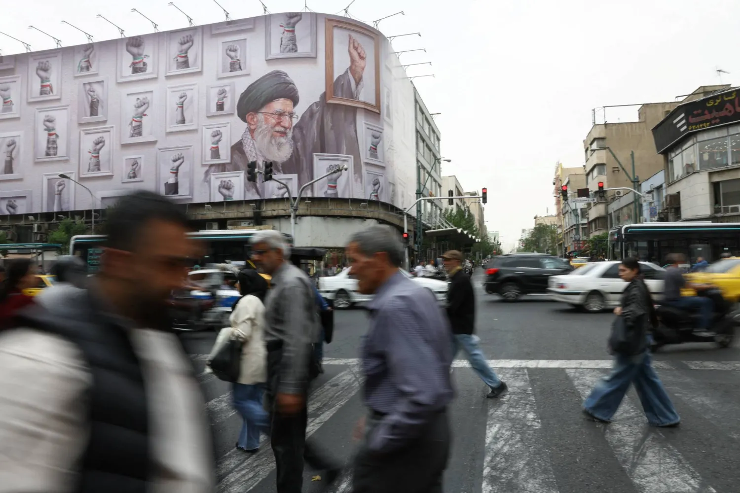 People walk near a billboard with an image of the late Iranian Supreme Leader Ali Khamenei, in Tehran, Iran, May 19, 2026. Majid Asgaripour/WANA (West Asia News Agency) via REUTERS 