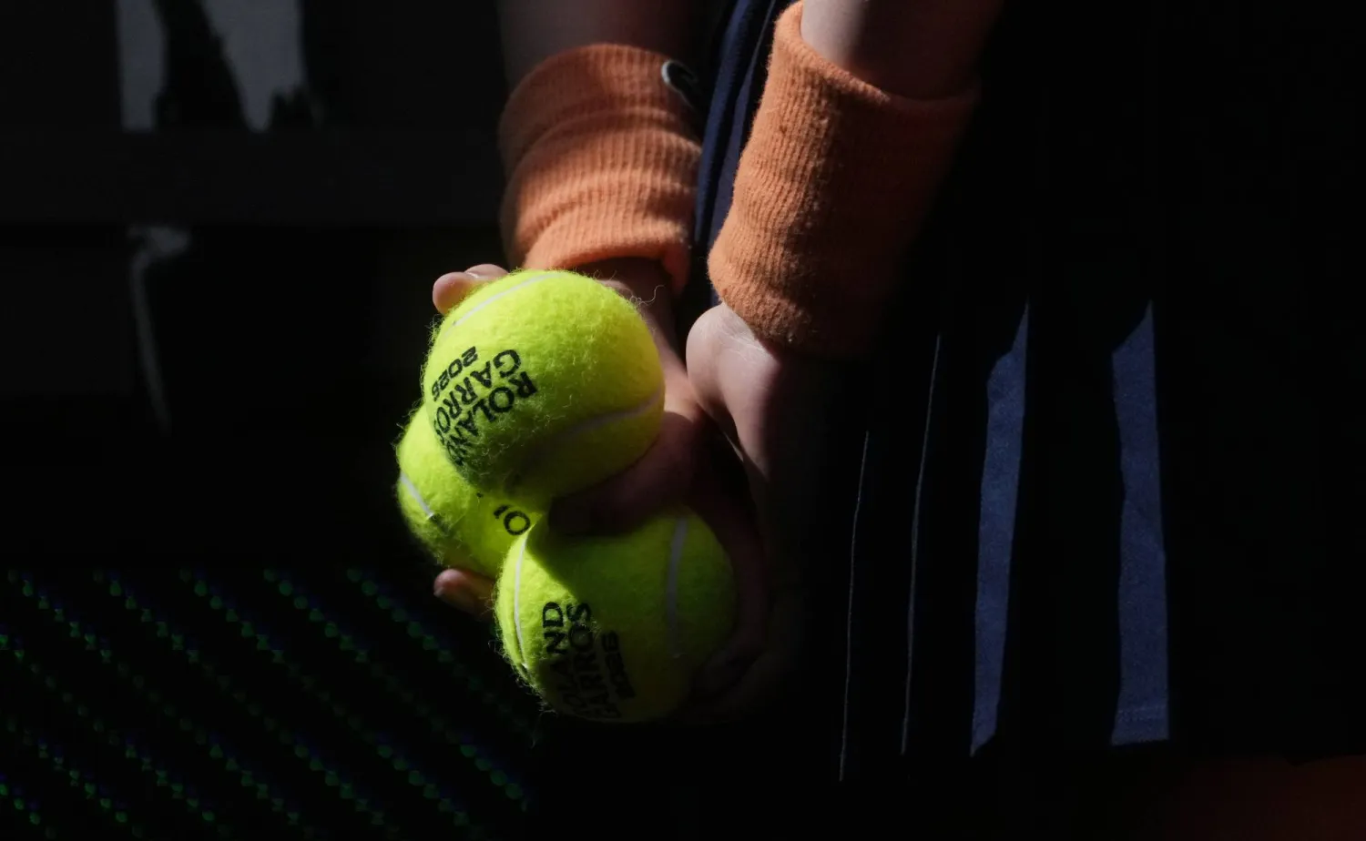 A ballgirl stands during the draw for the French Open tennis tournament, Thursday, May 21, 2026, at the Roland Garros stadium in Paris. (AP Photo/Thibault Camus)
