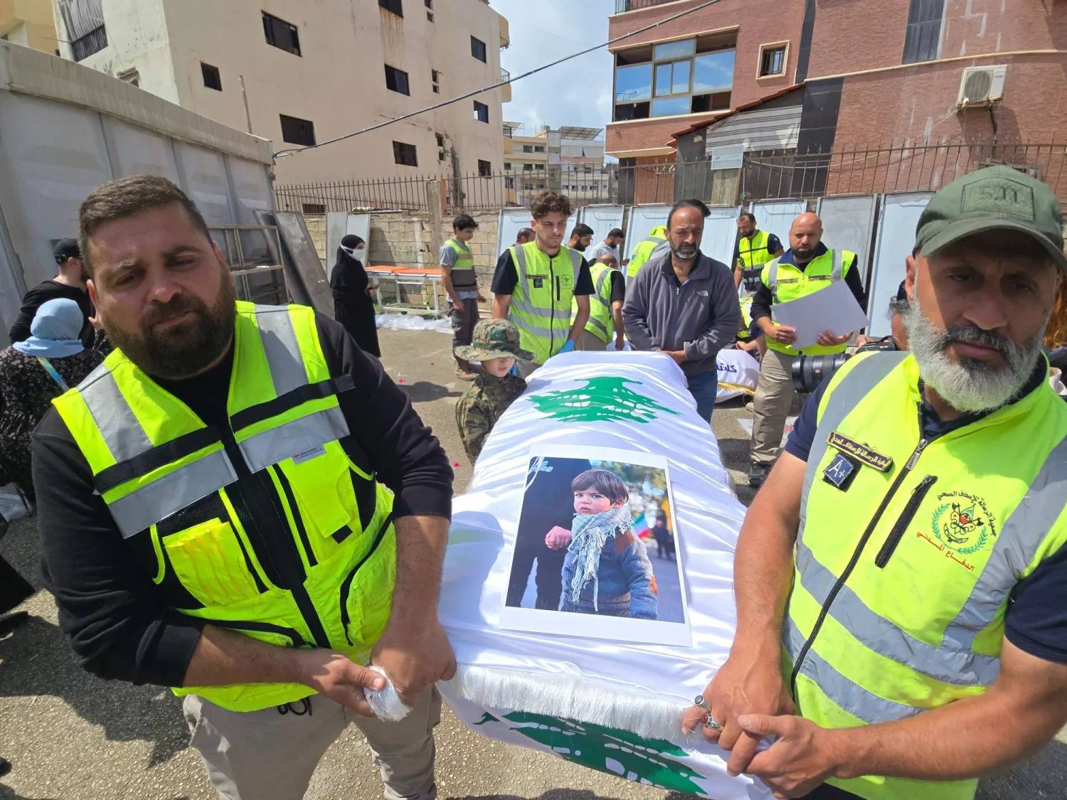 Officials carry the bodies of victims killed in the Israeli strike on the southern village of Deir Qanoun al-Nahr, outside Jabal Amel Hospital in the Tyre area of south Lebanon, before the bodies were transferred to their hometown for burial, as security conditions prevented families from holding the farewell ceremony in the village, on May 21, 2026. (Photo by KAWANT HAJU / AFP)