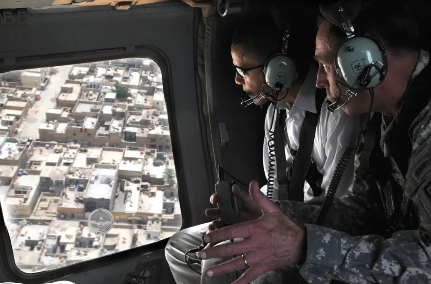 A 2008 photo released by the Pentagon shows David Petraeus briefing Barack Obama, then a US senator, on a plan to secure Sadr City in eastern Baghdad during an aerial tour over the area.