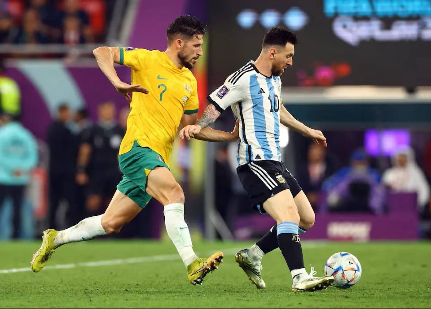 Soccer Football - FIFA World Cup Qatar 2022 - Round of 16 - Argentina v Australia - Ahmad bin Ali Stadium, Al Rayyan, Qatar - December 3, 2022 Argentina's Lionel Messi in action with Australia's Mathew Leckie REUTERS/Bernadett Szabo