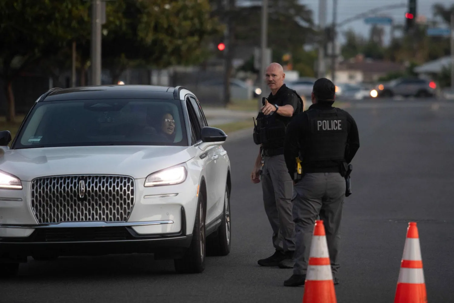 Garden Grove police direct evacuees towards a shelter after a chemical leak from a large storage tank threatened residents in Garden Grove, California on May 22, 2026. (Photo by Blake Fagan / AFP)