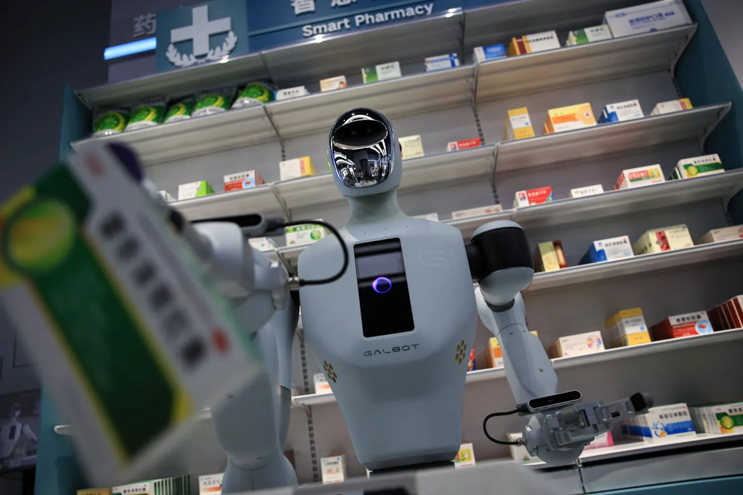A robot holding a medicine box at the simulated pharmacy of the Beijing Humanoid Robot Innovation Center (EPA)