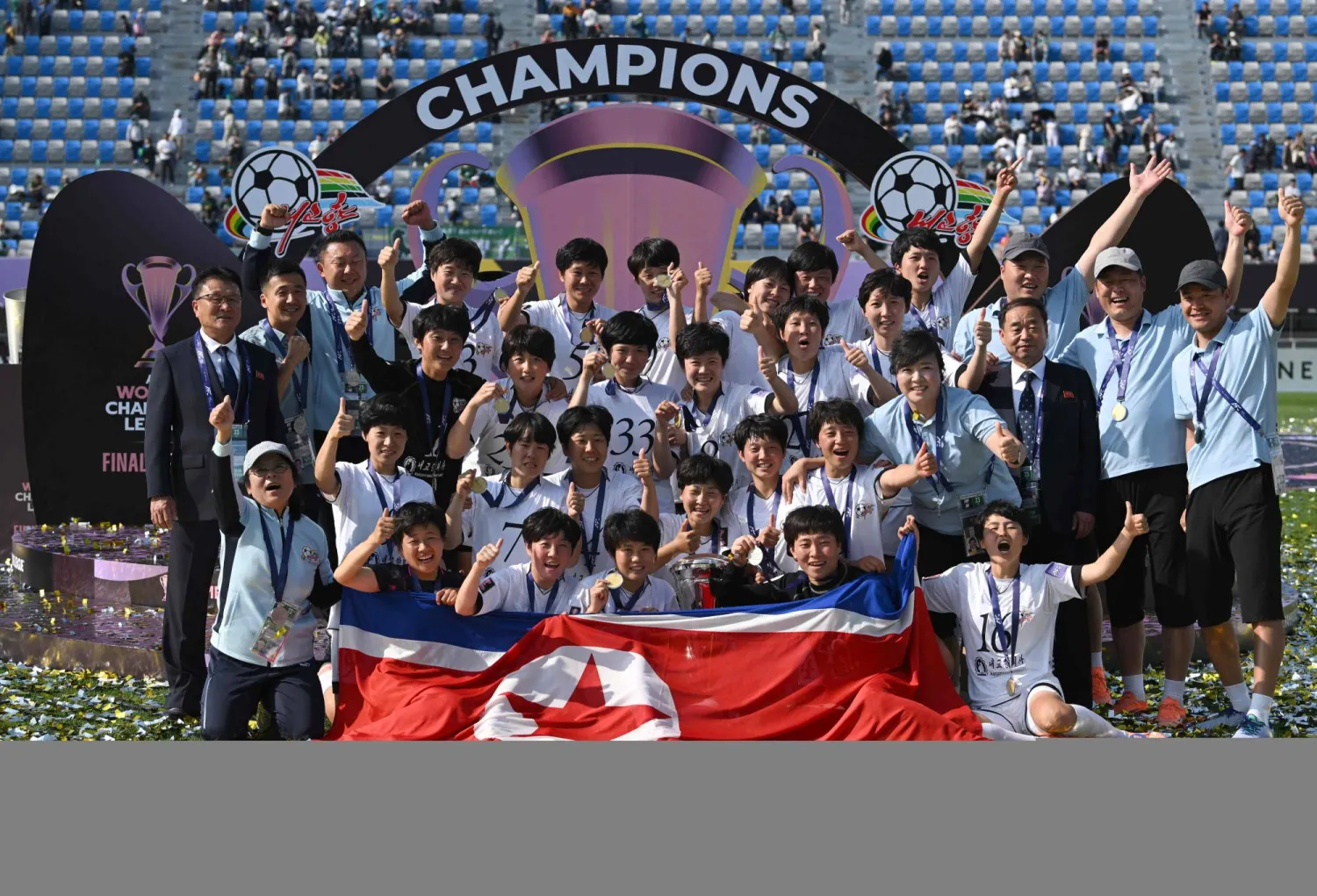 Naegohyang Women's FC players celebrate with the trophy during the victory ceremony after the AFC Women's Champions League final football match between North Korea's Naegohyang Women's FC and Japan's Tokyo Verdy Beleza in Suwon on May 23, 2026. (Photo by Jung Yeon-je / AFP)