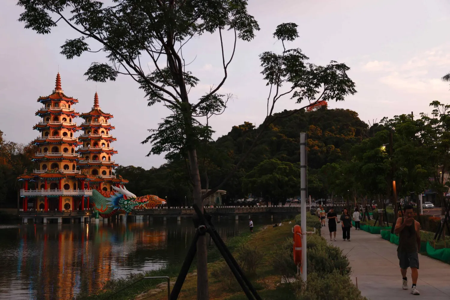 People walk past the Dragon and Tiger Pagodas at Lotus Pond in Kaohsiung, Taiwan, May 15, 2026. REUTERS/Ann Wang