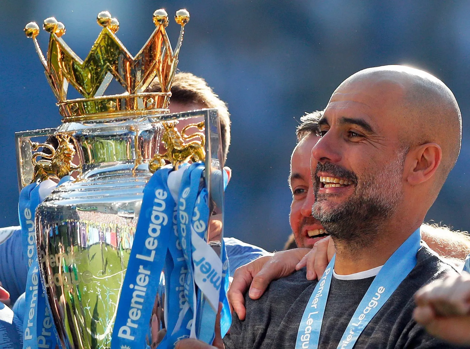 Manchester City coach Pep Guardiola lifts the English Premier League trophy after the English Premier League soccer match between Brighton and Manchester City at the AMEX Stadium in Brighton, England, Sunday, May 12, 2019. (AP)
