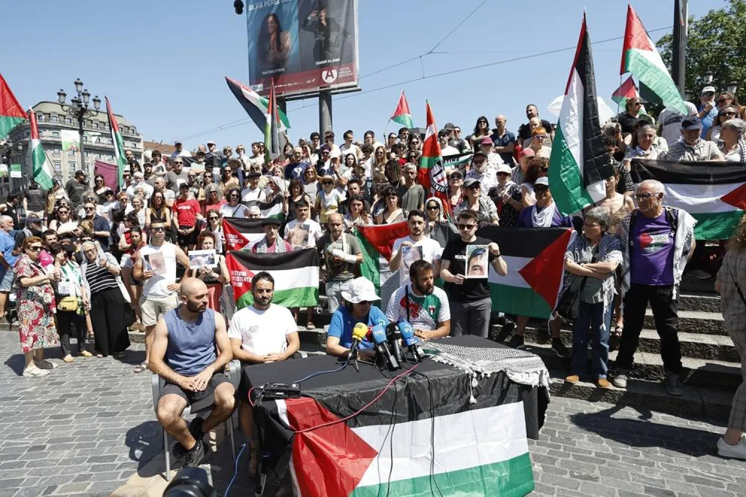 People hold Palestinian flags during a press conference organized by Basque Delegation within the Global Sumud Flotilla, in Bilbao, northern Spain, 24 May 2026. (EPA)