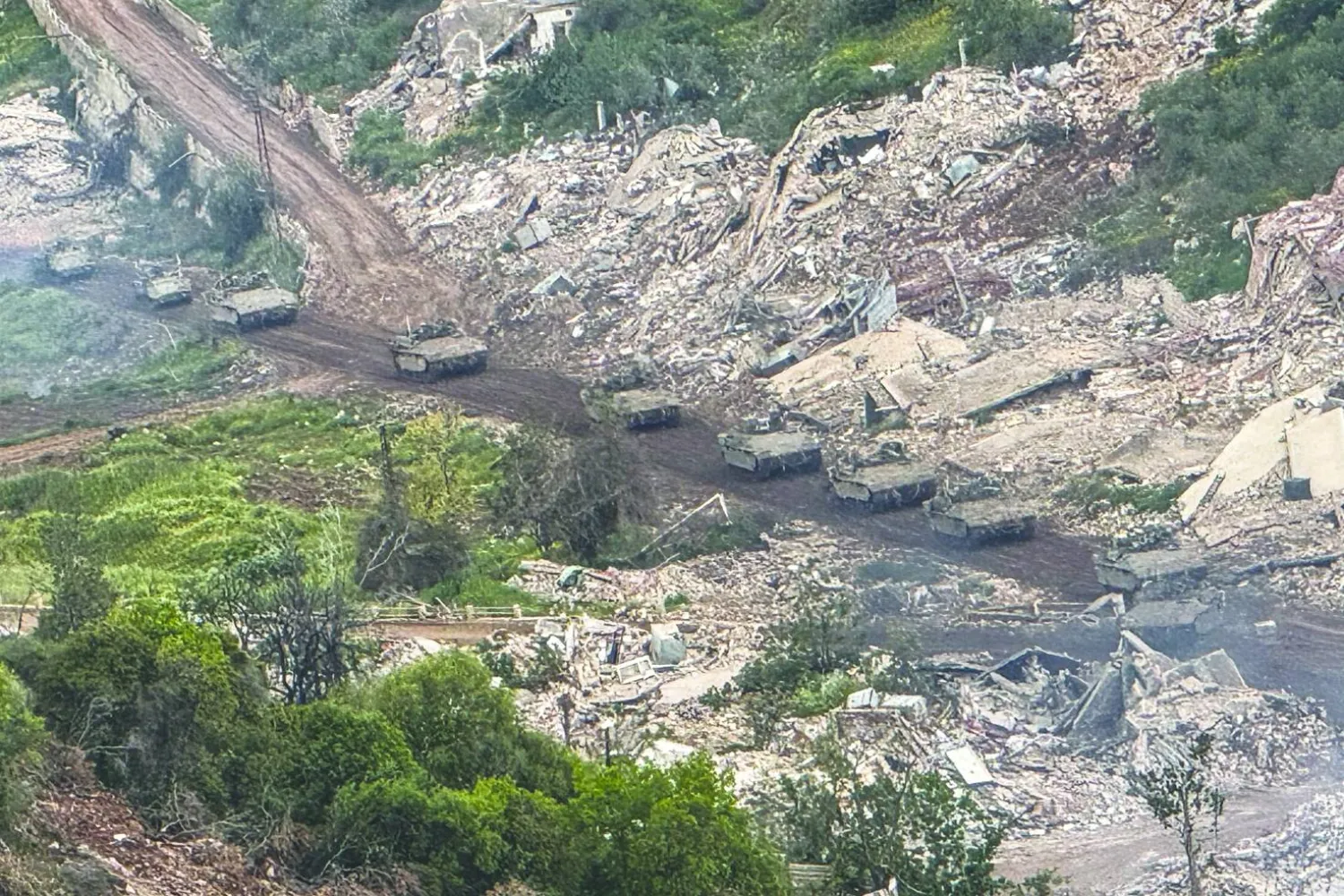 Israeli military vehicles drive on a Lebanese road towards the Israel-Lebanon border, as seen from northern Israel, May 4, 2026. REUTERS/Avi Ohayon