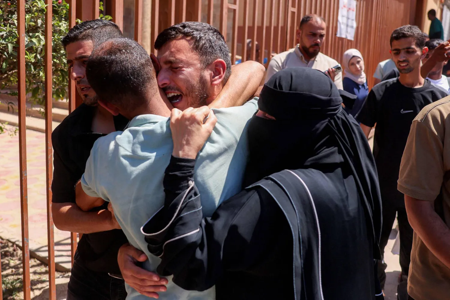 Mourners grieve for six-year-old Palestinian girl Menna Abu Labda, who was killed following Israeli bombardment, outside Nasser Medical Complex in Khan Younis in the southern Gaza Strip on May 25, 2026. (AFP)