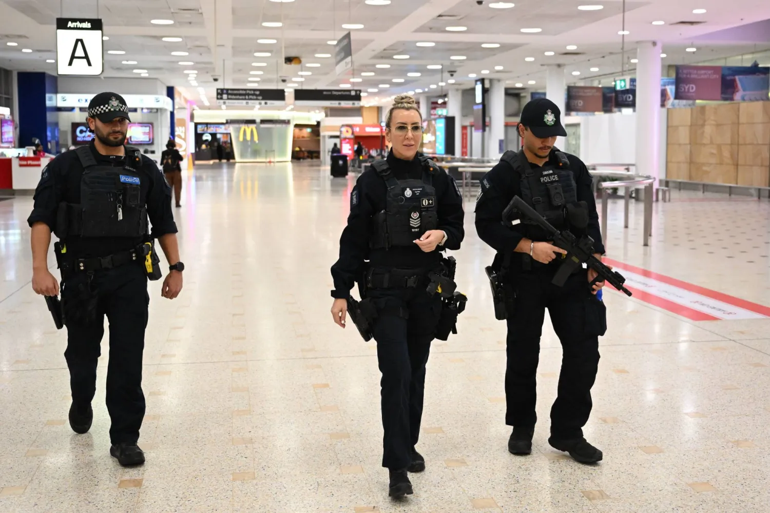 Australian Federal Police officers patrol Sydney International Airport, in Sydney, Australia, 26 May 2026. EPA/DEAN LEWINS 