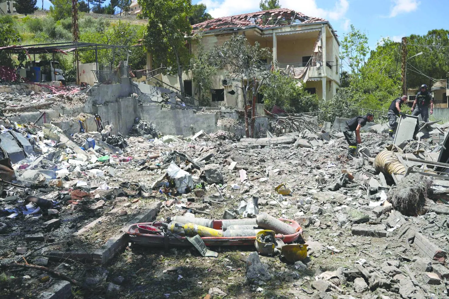 Emergency workers look to recover equipment from a civil defense center damaged in an Israeli air strike on the southern Lebanese city of Nabatiyeh on May 24, 2026.  (Photo by Abbas Fakih / AFP)