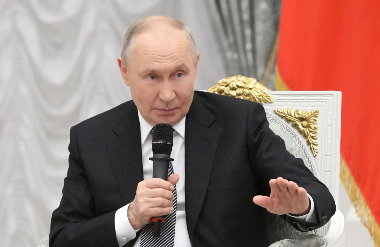 In this pool photograph distributed by the Russian state agency Sputnik, Russia's President Vladimir Putin meets with graduates of the "Time of Heroes" program, at the Kremlin in Moscow on May 22, 2026. (Photo by Alexey NIKOLSKY / POOL / AFP)