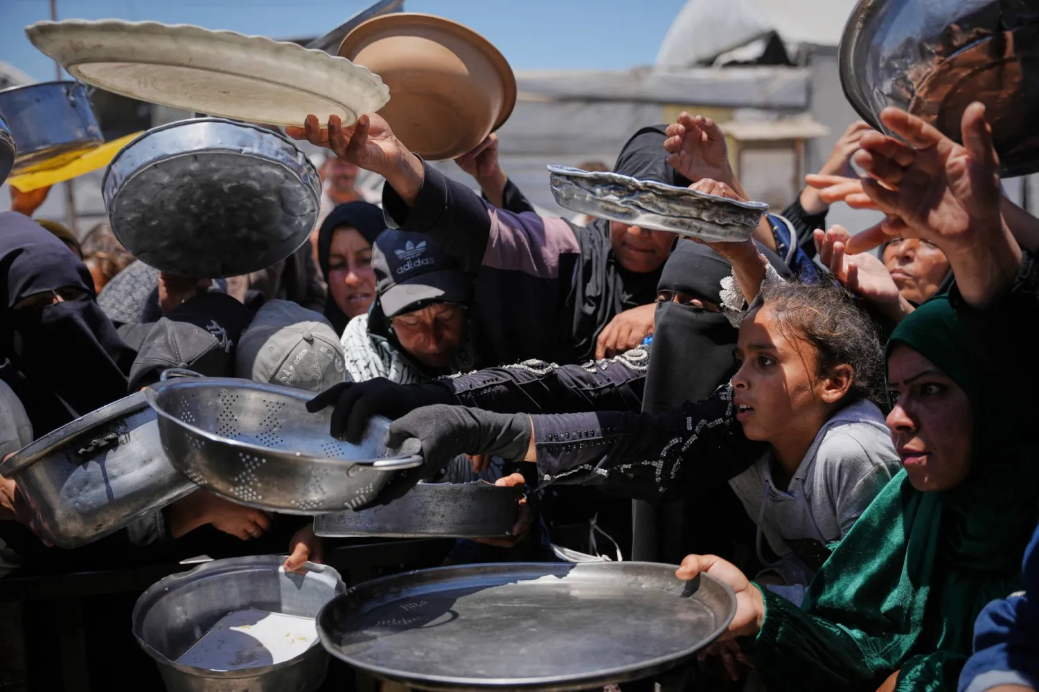 Palestinians wait to receive donated food at a distribution center in Khan Younis, Gaza Strip, Wednesday, May 27, 2026. (AP Photo/Abdel Kareem Hana)