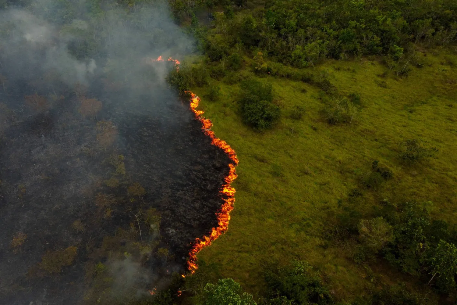 (FILES) Smoke from illegal fires lit by farmers rises in Manaquiri, Amazonas state, on September 6, 2023. (Photo by MICHAEL DANTAS / AFP)