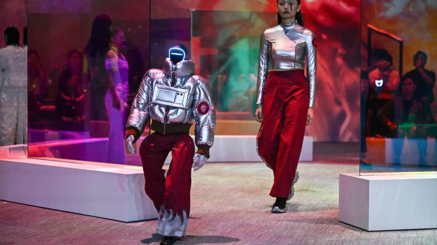 Each human model and their android companion took turns to strut their stuff in unison. Pedro PARDO / AFP
