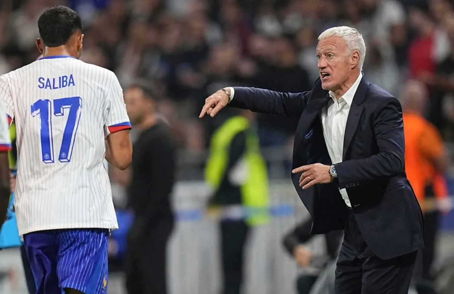 France head coach Didier Deschamps, right, instructs his players after their second goal during the UEFA Nations League match between France and Belgium at the Groupama stadium in Decines, outside Lyon, France, Monday, Sept. 9, 2024. (AP)