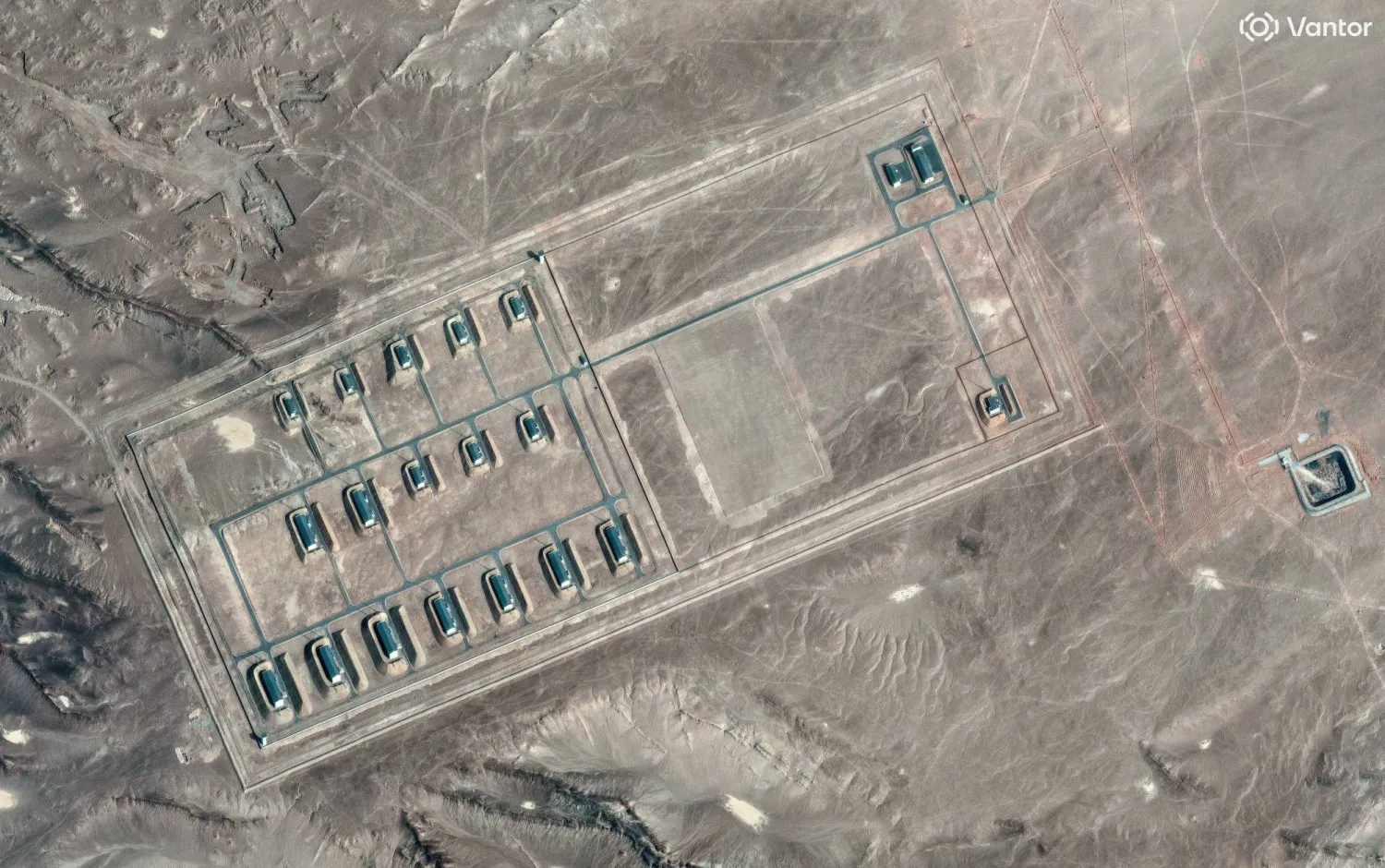 A satellite image shows what security analysts say is a fortified weapons storage installation, revealing revetments around the building, a perimeter wall and guard towers, in the Xinjiang Uyghur Autonomous Region, China, March 19, 2026. Vantor/Handout via REUTERS    