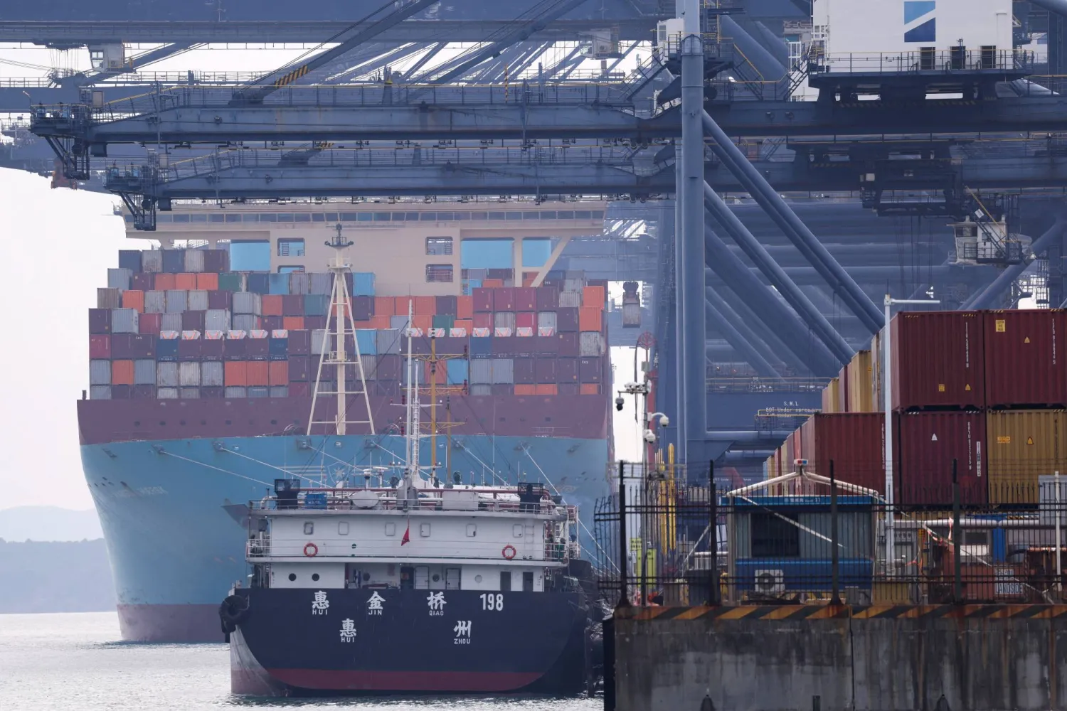 FILE PHOTO: A cargo ship with containers docks at a terminal of the Yantian port in Shenzhen, Guangdong province, China October 30, 2025. REUTERS/Tingshu Wang/File Photo