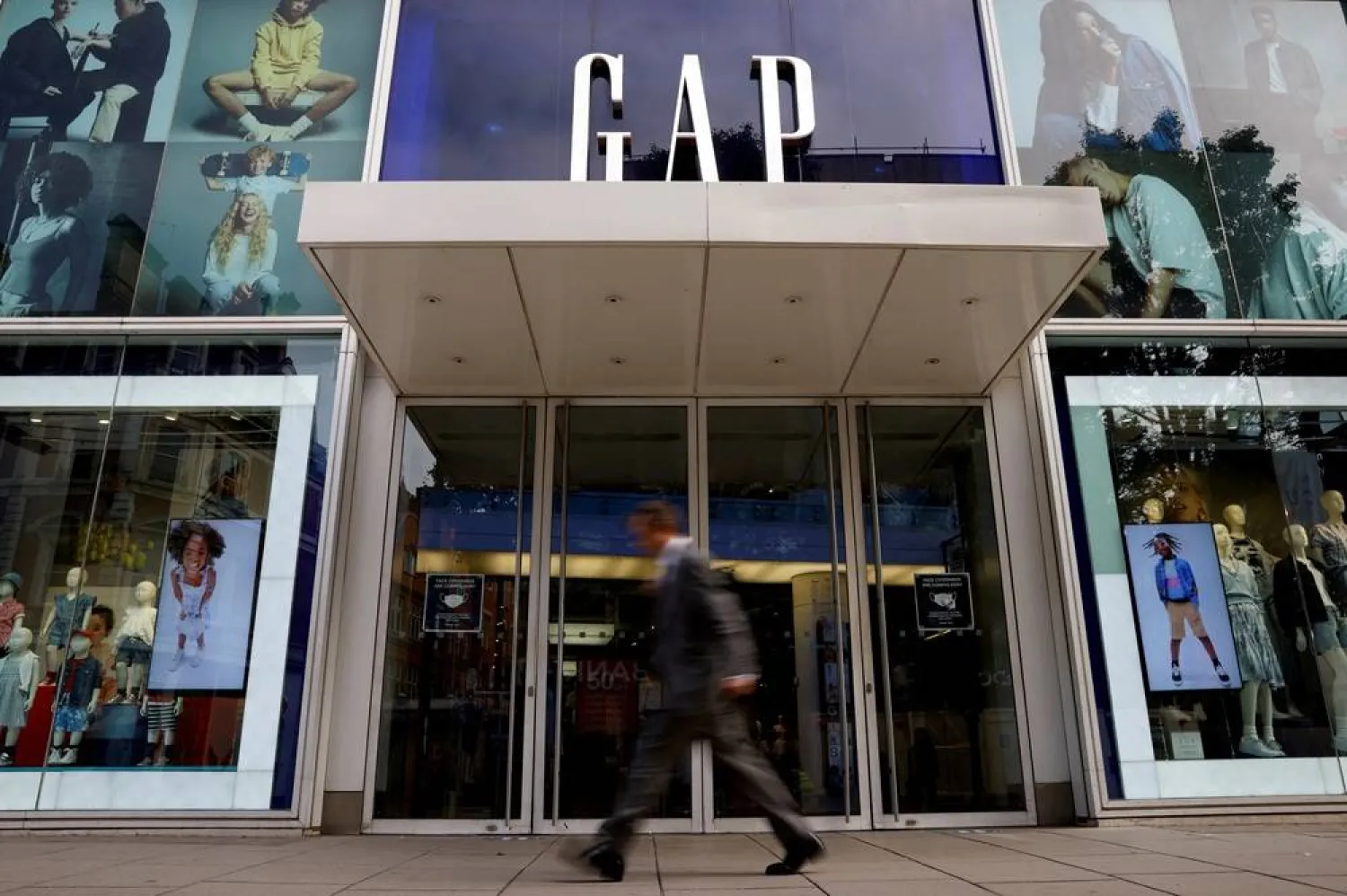 A man walks past a Gap store on Oxford Street in London, Britain, July 1, 2021. (Reuters) 