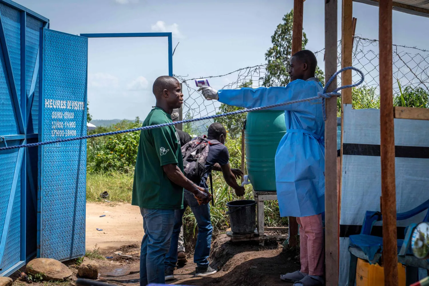 A healthcare worker takes a visitor's temperature at Rwampara Hospital in Ituri, in the eastern Democratic Republic of the Congo, on May 26, 2026. (Photo by Glody MURHABAZI / AFP)