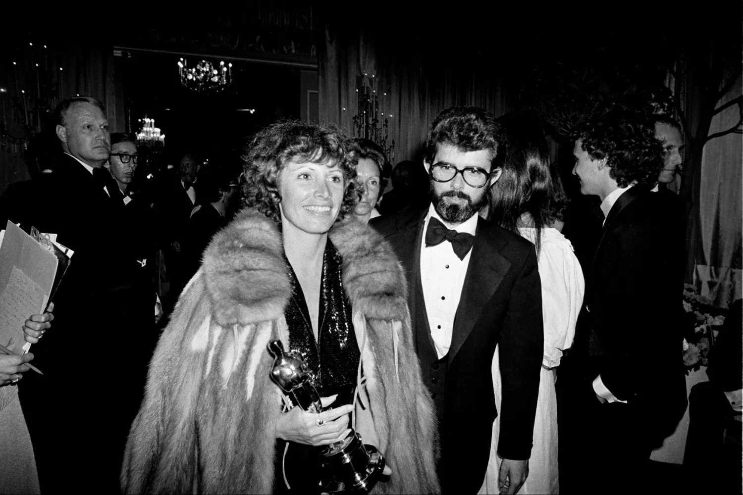 Marcia Lucas, wife of director George Lucas, right, carries her Oscar statuette as they arrive at a post Academy Awards party at the Beverly Hilton Hotel in Los Angeles, April 4, 1978. (AP) 