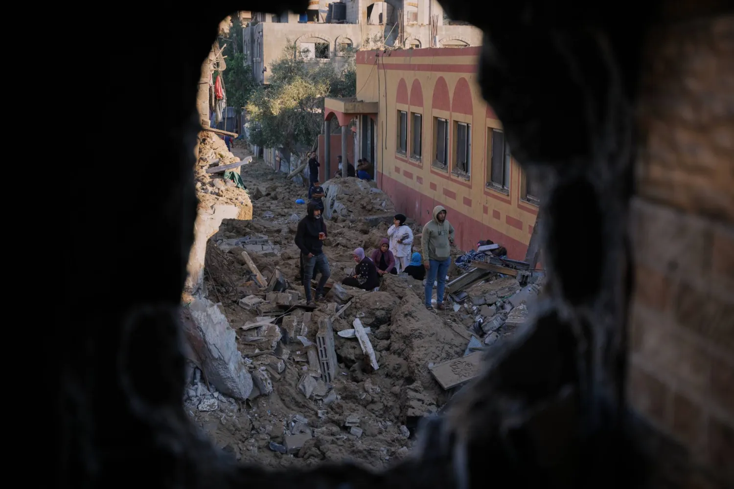 Palestinians inspect the rubble of a building destroyed in an Israeli strike in Deir al-Balah, in the central Gaza Strip, Friday, May 29, 2026. (AP Photo/Abdel Kareem Hana)
