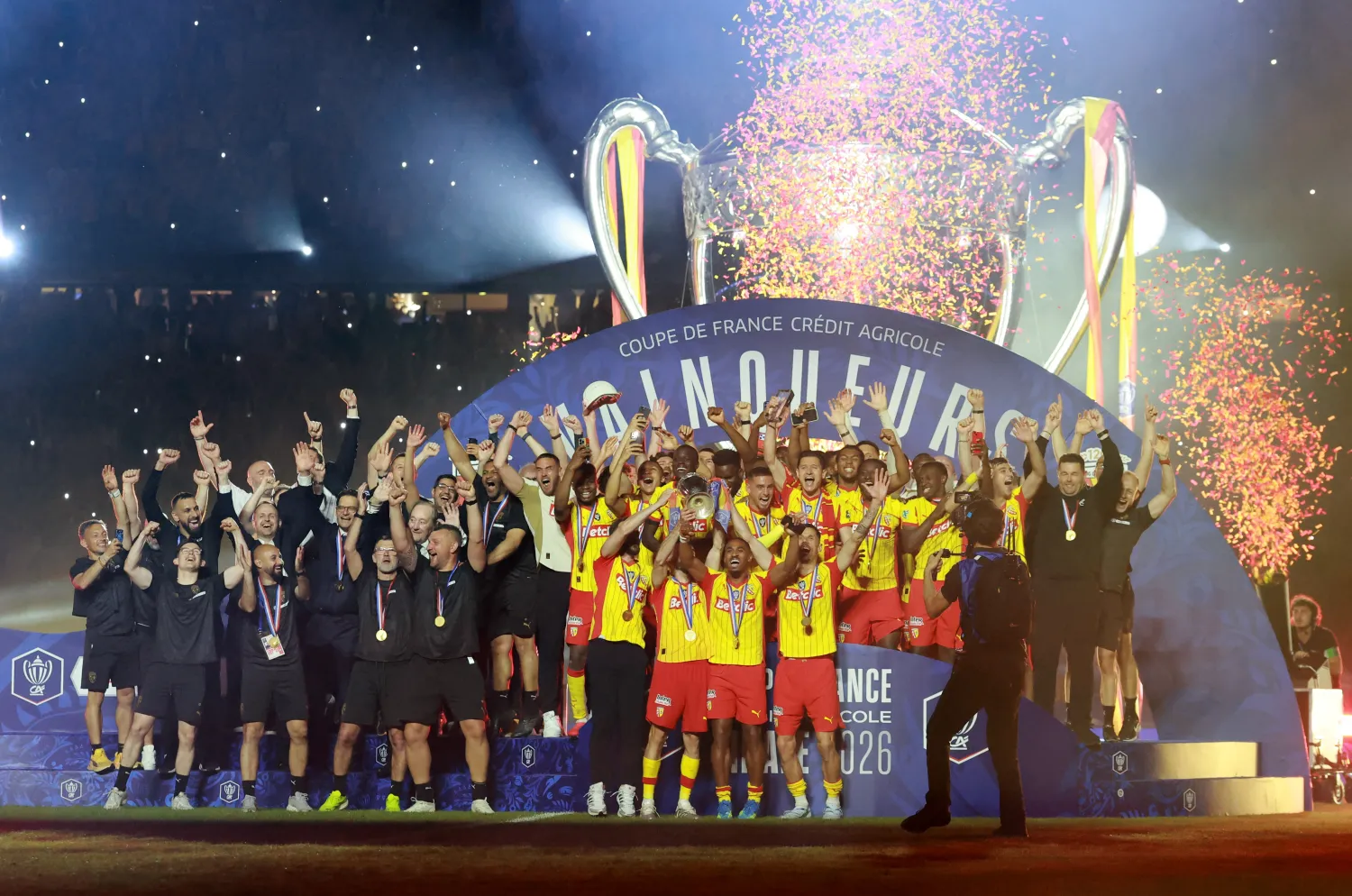 Soccer Football - Coupe de France - Final - RC Lens v OGC Nice - Stade de France, Saint Denis, France - May 22, 2026 RC Lens' Adrien Thomasson lifts the trophy as he celebrates with teammates after winning the Coupe de France REUTERS/Stephanie Lecocq