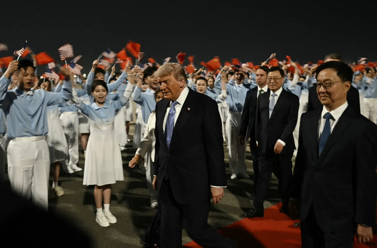 US President Donald Trump (C) is escorted by China's Vice President Han Zheng (R) upon his arrival at Beijing Capital Airport in Beijing on May 13, 2026. (AFP)