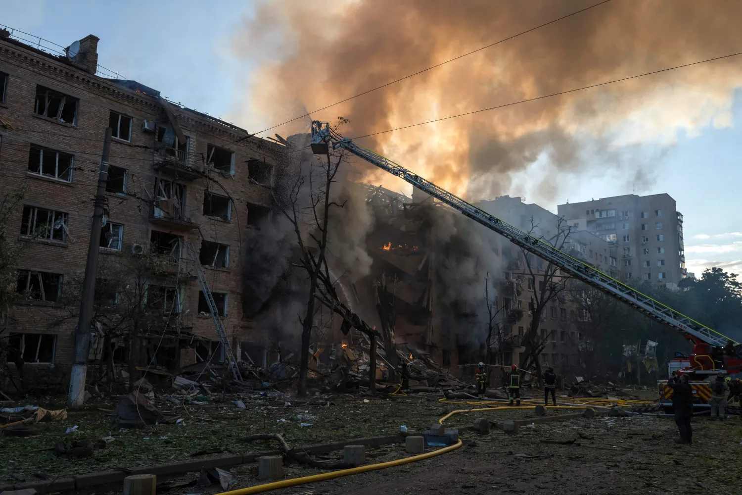 Firefighters work to extinguish a fire at the site of a heavily damaged building following Russian strikes to the Ukrainian capital in Kyiv on May 24, 2026, amid the Russian invasion of Ukraine. (AFP) 