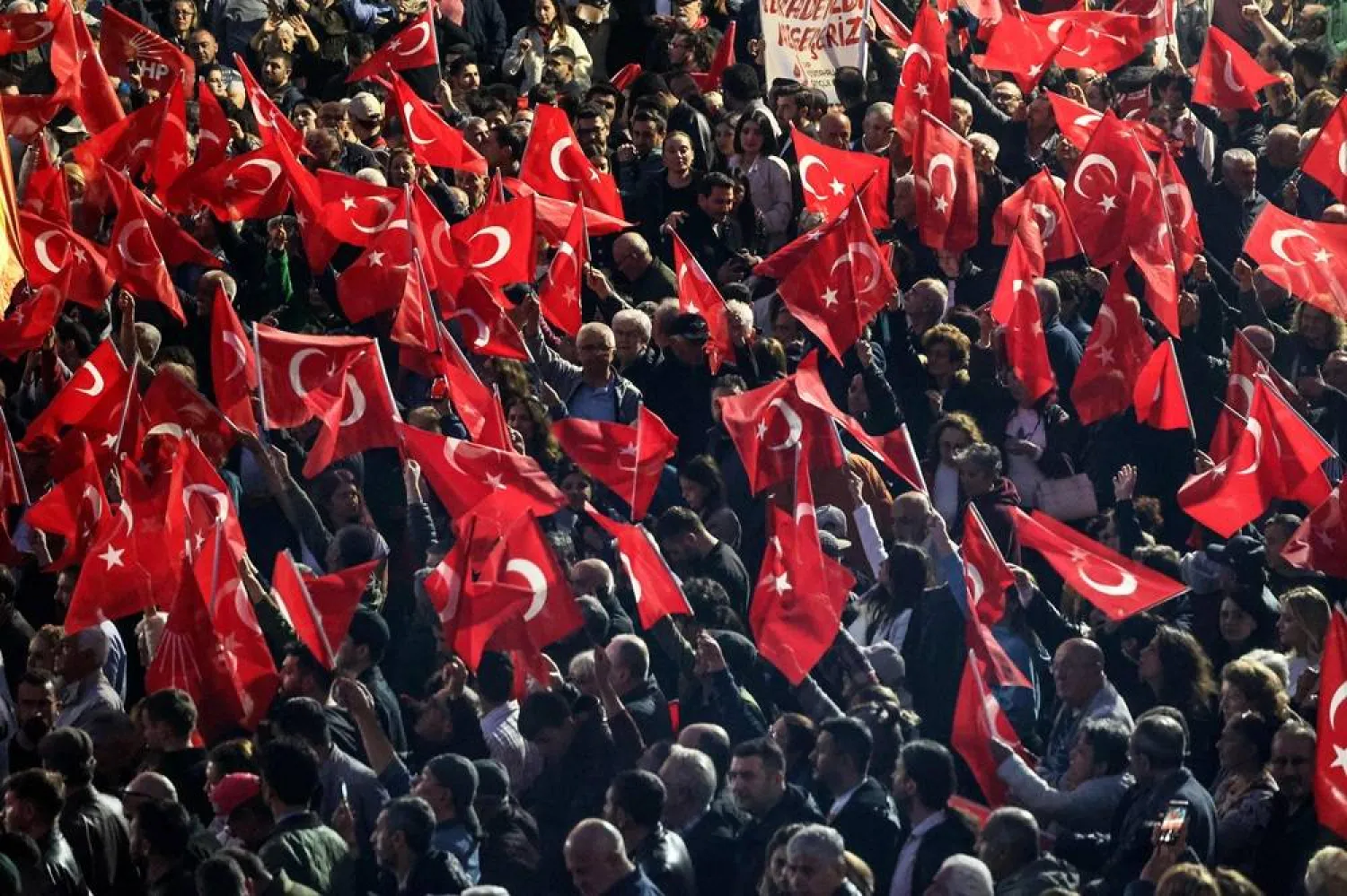 Supporters wave Turkish national flags as the leader of Republican People's Party (CHP) delivers a speech during a protest against allegations of vote buying at the CHP congress in November 2023, at their party headquarters in Ankara on May 22, 2026. (AFP)