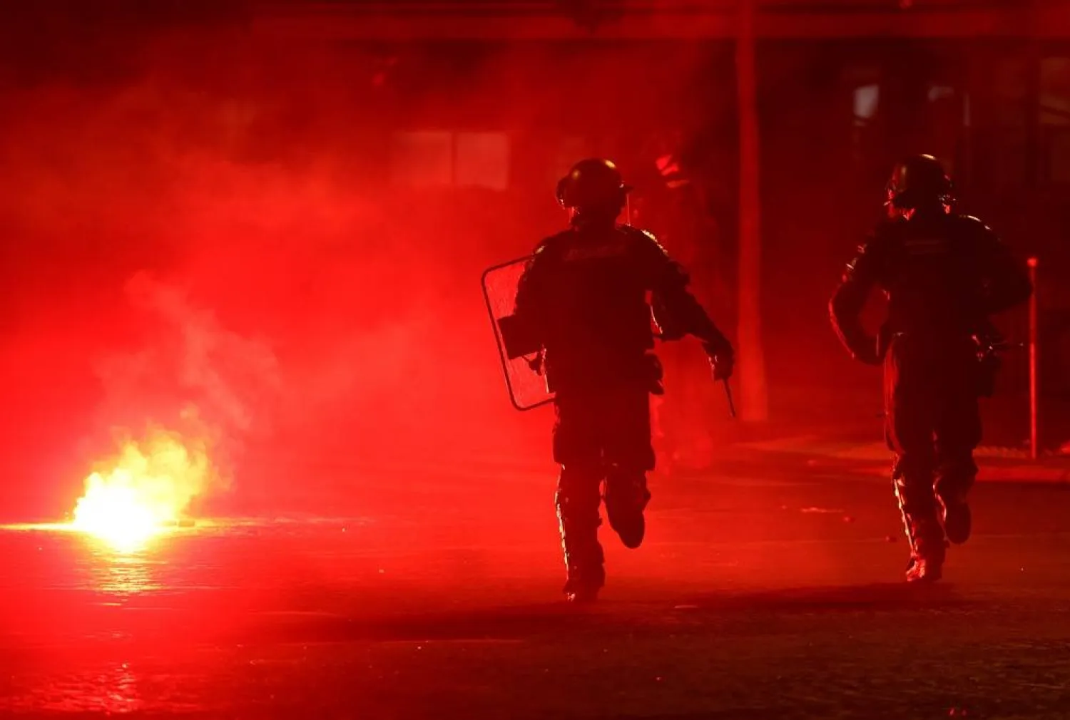 Football - UEFA Champions League - Paris St Germain fans celebrate winning the UEFA Champions League - Paris, France - May 31, 2026 Police officers protect themselves from a flare after Paris St Germain won the UEFA Champions League. (Reuters)