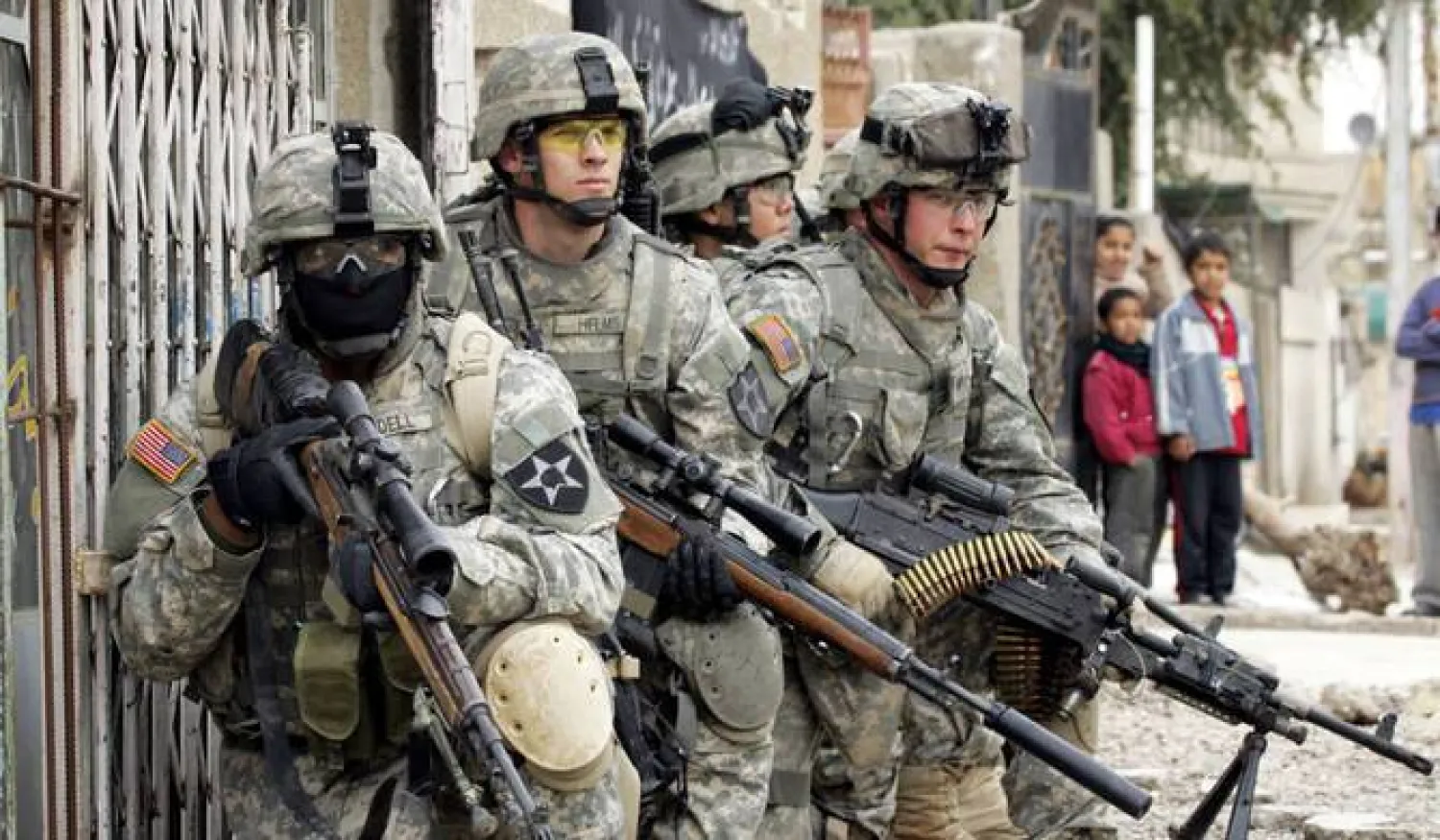 US Army soldiers from the 5-20 Infantry Division take up positions to provide cover for fellow soldiers as part of the launch of Operation Arrowhead Strike Six in the Shaab neighborhood of northern Baghdad, 06 February 2007. (AFP)