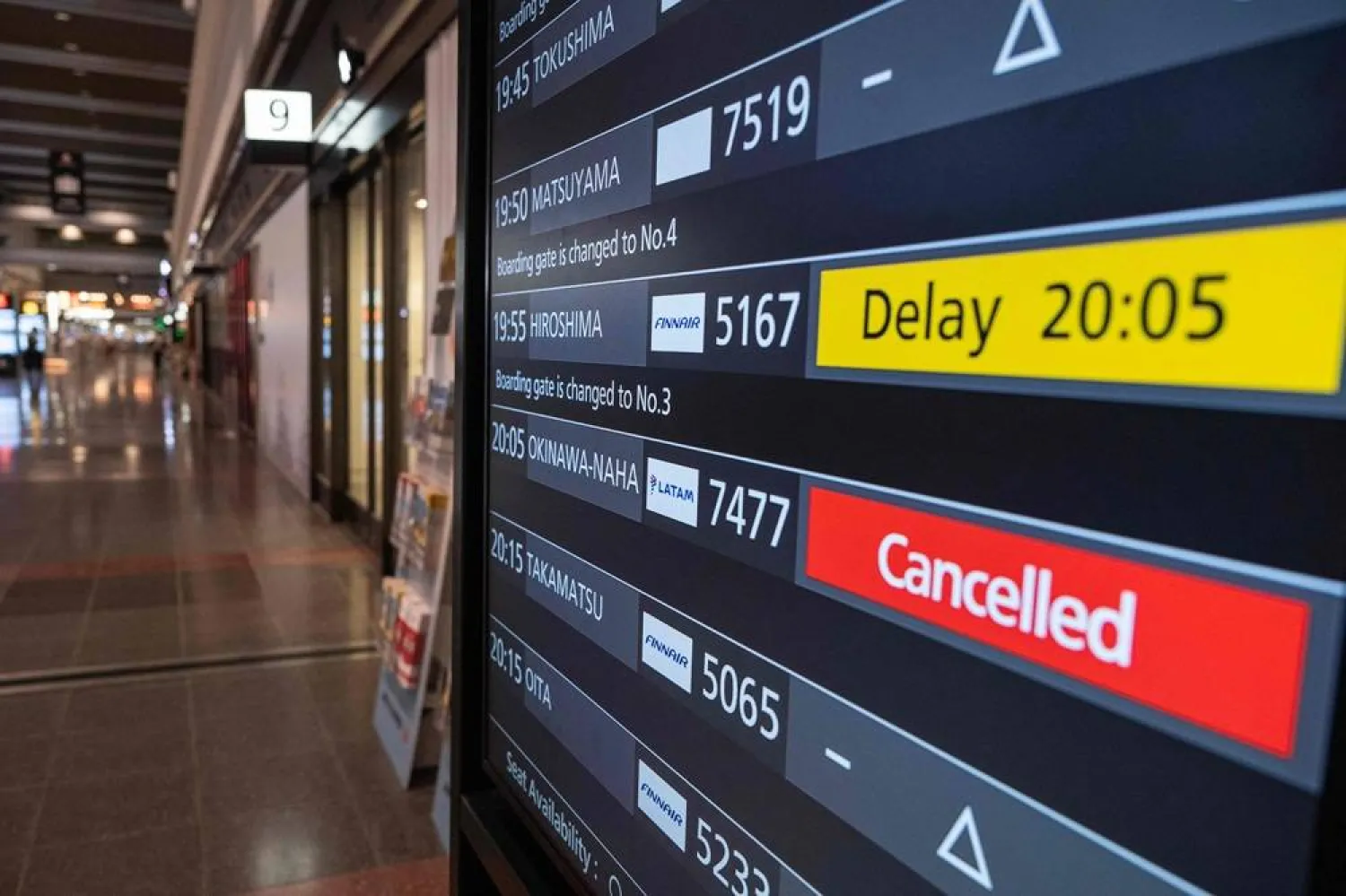  A departures board shows a cancelled flight to Okinawa after Severe Tropical Storm Jangmi shut down the airport there as it moved toward mainland Japan, at Haneda Airport in Tokyo on June 1, 2026, as airlines began suspending service across the region. (AFP) 