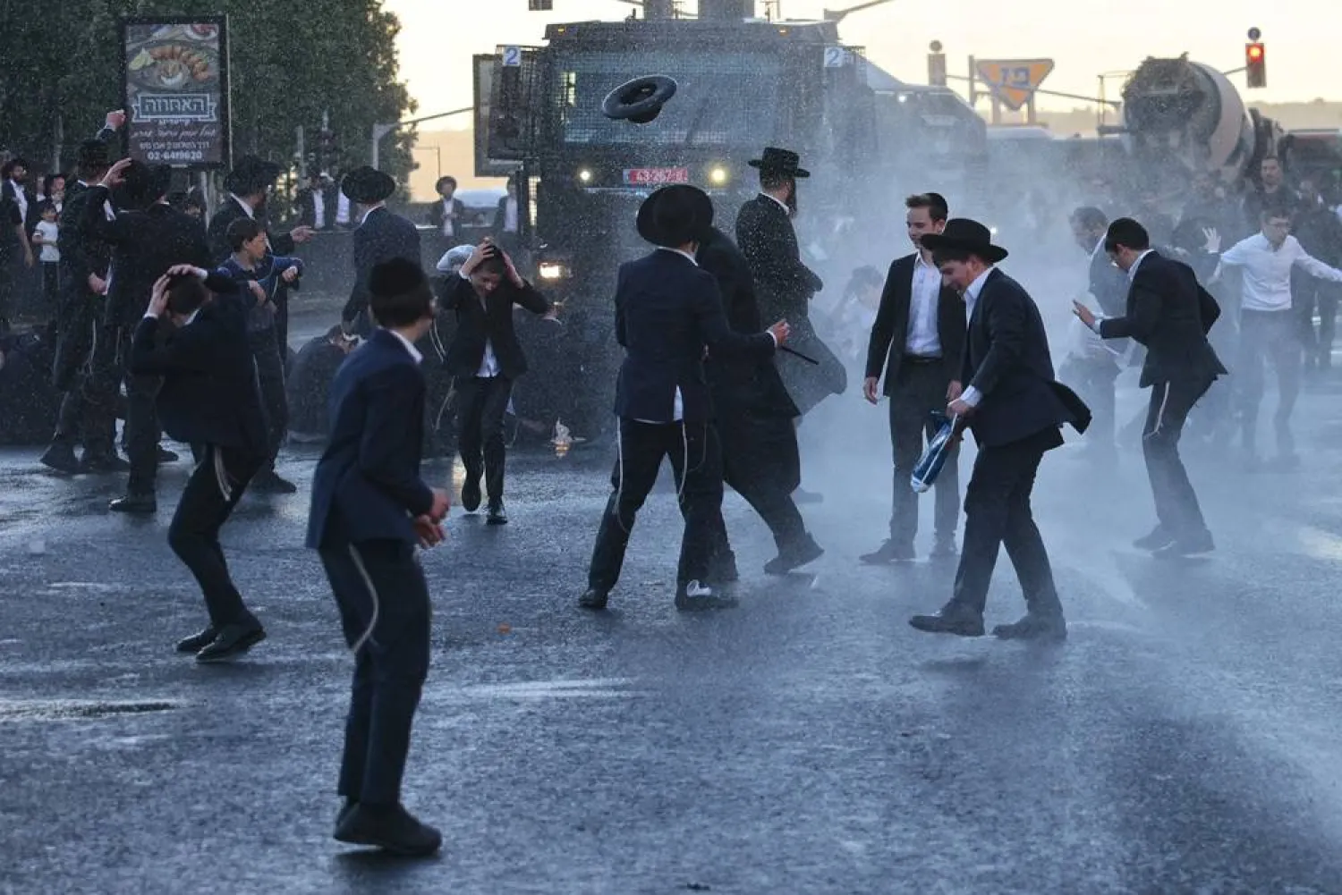 Israeli police use a water cannon to disperse ultra-Orthodox Jews protesting against conscription by blocking the entrance to Jerusalem, on June 1, 2026. (AFP)