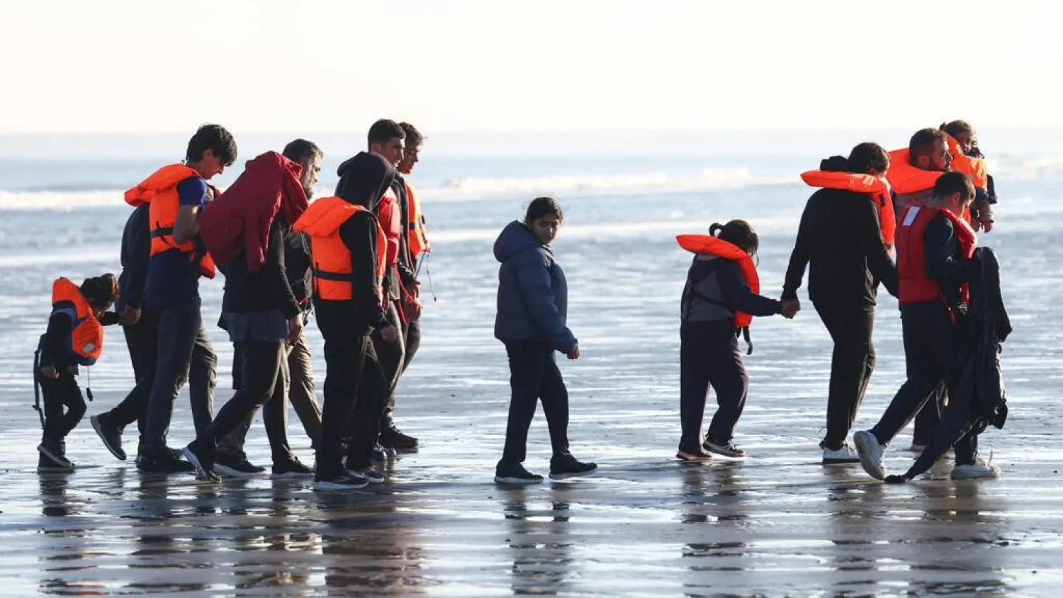 Migrants walk away from the beach after a failed attempt to cross the English Channel to reach Britain, from Petit-Fort-Philippe beach in Gravelines, near Calais, France, September 27, 2025. Abdul Saboor, Reuters
