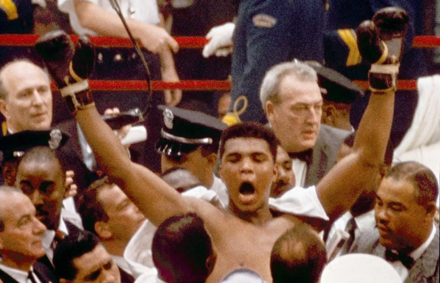 In this Feb. 25, 1964, file photo, Muhammad Ali, or Cassius Clay at the time, strikes a familiar pose as he shouts "I am the greatest," as he leaves the ring, arms raised, following his defeat of former heavyweight boxing champion Sonny Liston, in Miami Beach, Fla. (AP file) 