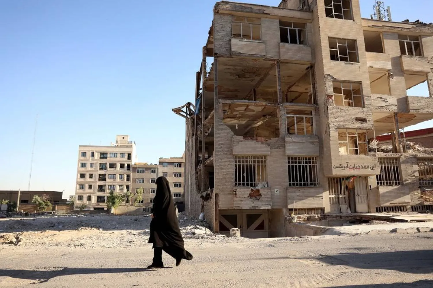  An Iranian woman walks past a residential building, destroyed by previous US-Israeli airstrikes, in Tehran, Iran, 02 June 2026. (EPA)