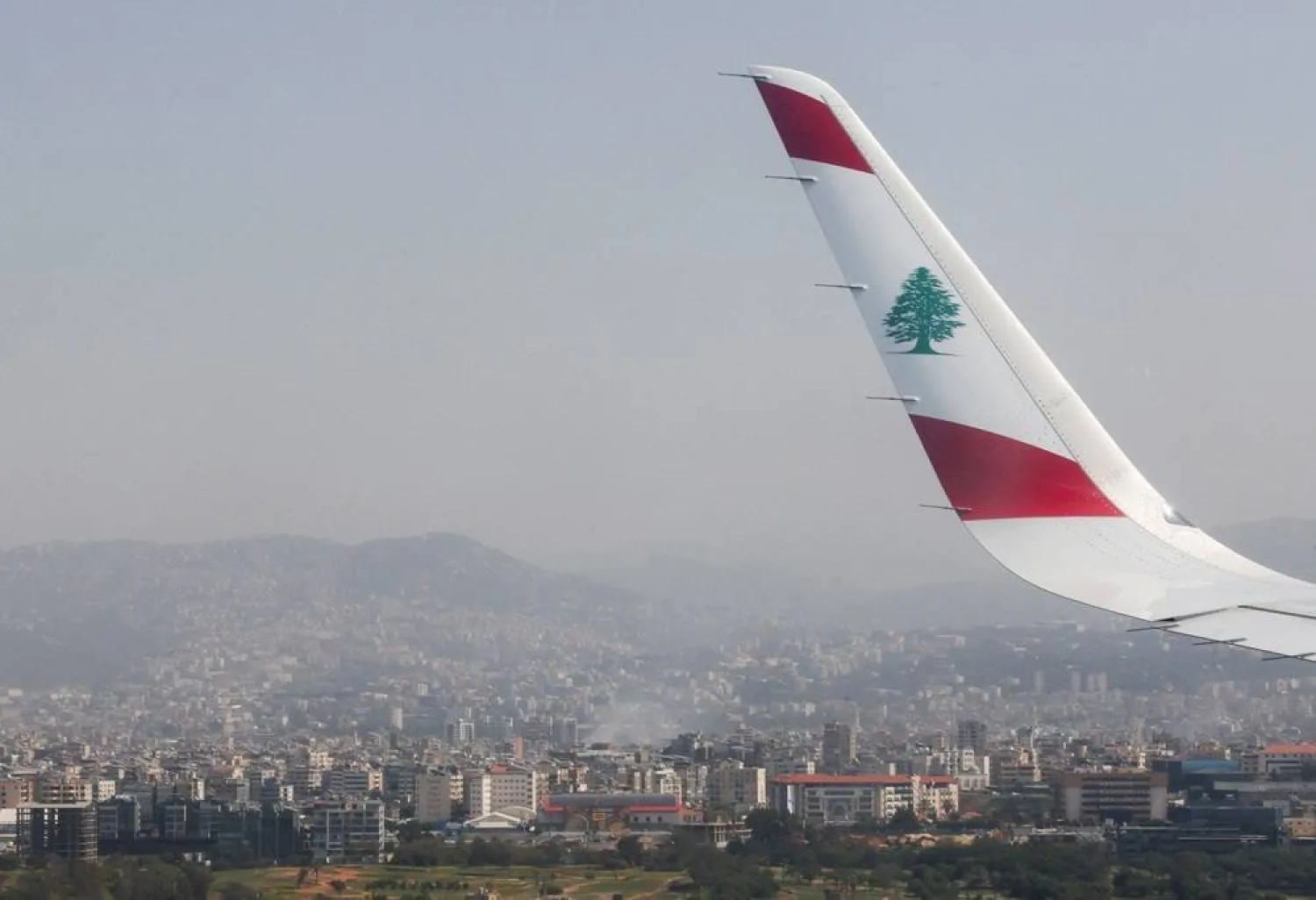 An aerial view from the window of a Lebanese Middle East Airlines (MEA) airplane shows smoke rising, after Israeli strikes following an escalation between Hezbollah and Israel, amid the US-Israeli conflict with Iran, in the southern suburbs of Beirut, Lebanon, March 12, 2026. (Reuters)
