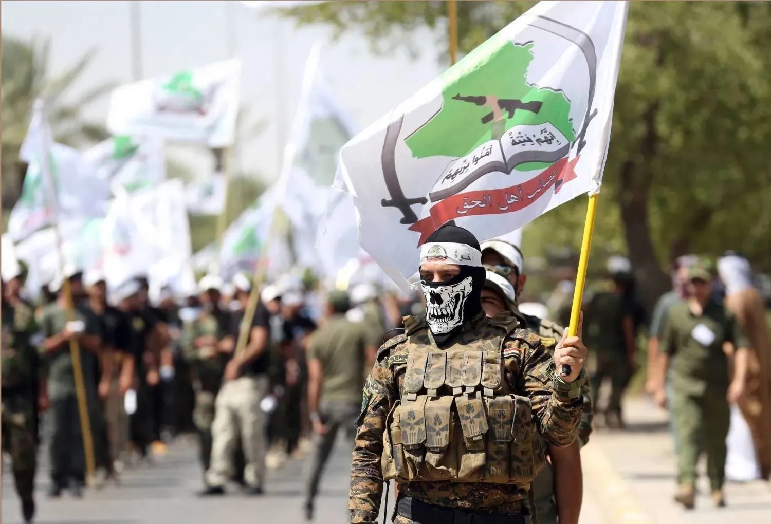 Members of Asaib Ahl al-Haq take part in a Quds Day march in Baghdad on July 1, 2016. (AP)