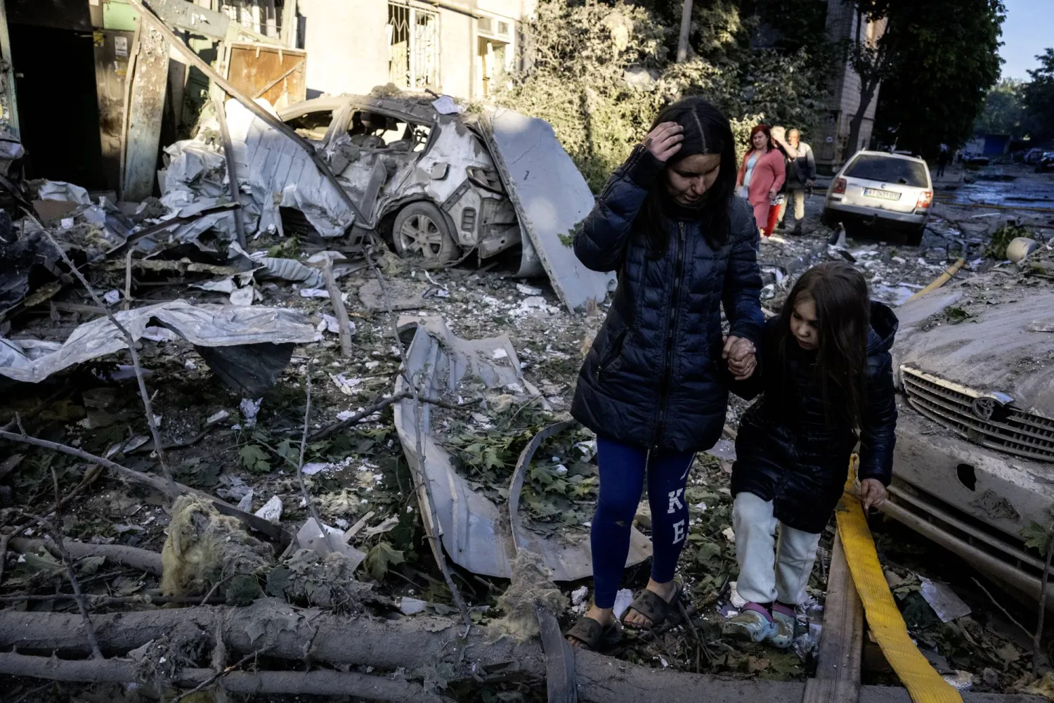 A local woman, Olga, 35, and her daughter Natalia, 6, walk at the site of a Russian strike on a residential area in Kyiv, Ukraine, 02 June 2026, amid the Russian invasion. EPA/MAXYM MARUSENKO