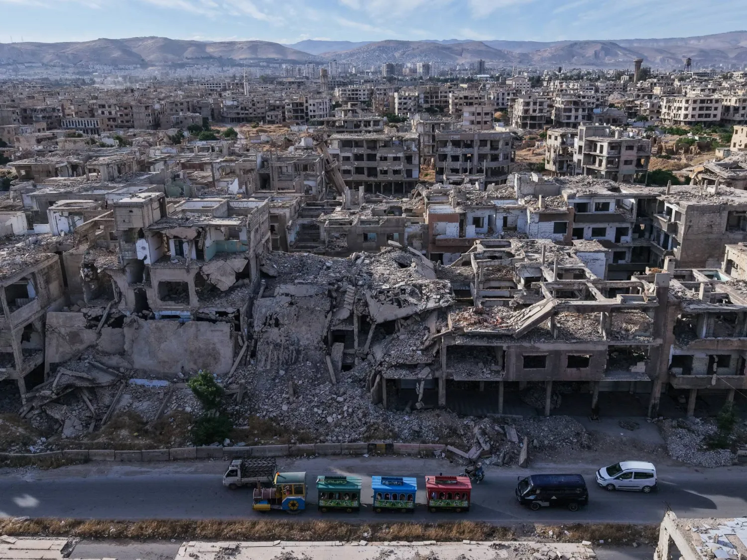 28 May 2026, Syria, Jobar: Syrians play in an Eid al-Adha amusement park in a devastated area amid the completely destroyed Jobar neighborhood on the outskirts of Damascus during the second day of the Muslim Feast of Sacrifice, Eid al-Adha. Photo: Moawia Atrash/dpa

