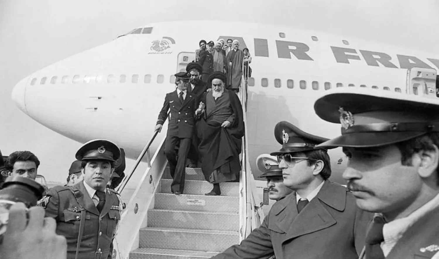 (FILES) Photo taken 01 February 1979 at Tehran airport of Ruhollah Khomeini (C) leaving the Air France Boeing 747 jumbo that flew him back from exile in France to Tehran. Getty Images