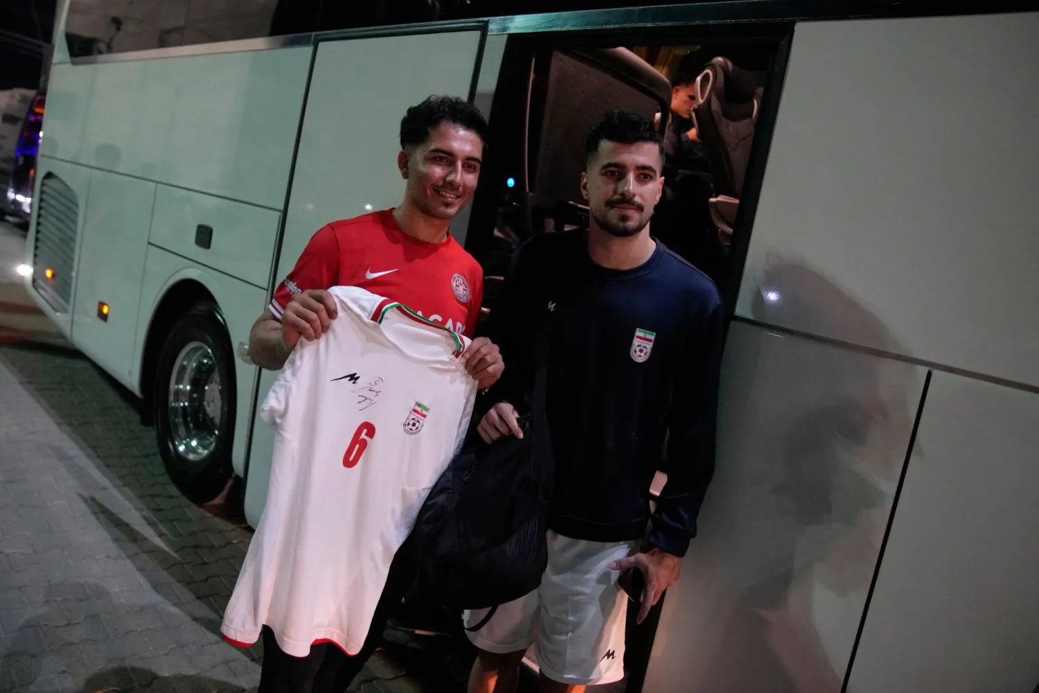 Iran's Saeid Ezatolahi, right, poses for a photo with a fan after a friendly soccer match between Iran and Mali, in Antalya, southern Türkiye, Thursday, June 4, 2026, ahead of the World Cup soccer tournament. (AP Photo/Khalil Hamra)